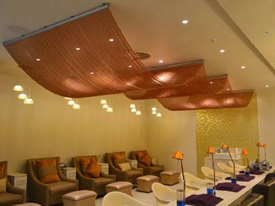 Brass color chain link curtain with hanging track is used for ceiling decoration.