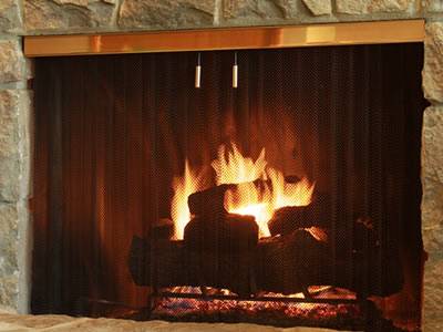 The charcoal is burning, and flat chainmail curtain is used as fireplace screen.