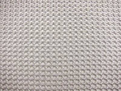 A piece of aluminum chainmail sheet is on the white background.