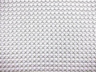 A piece of stainless steel chainmail sheet is on the white background.