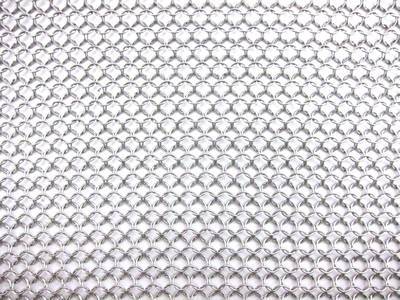 A piece of stainless steel chainmail sheet is on the white background.