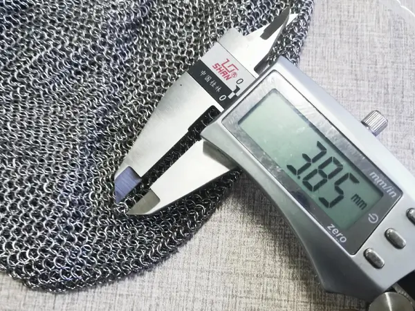 Measure chainmail curtain iron ring diameter with a caliper.