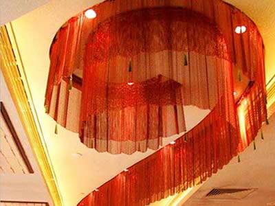 Chinese red flexible mesh curtain is installed in the luxury building as a lamp shade.