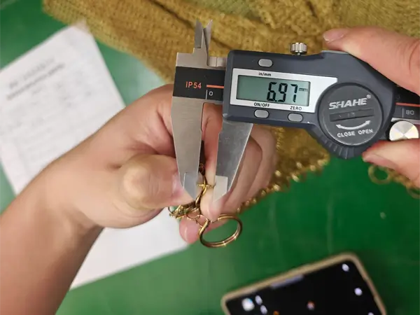 Measure the gold chainmail curtain iron ring diameter with a caliper.