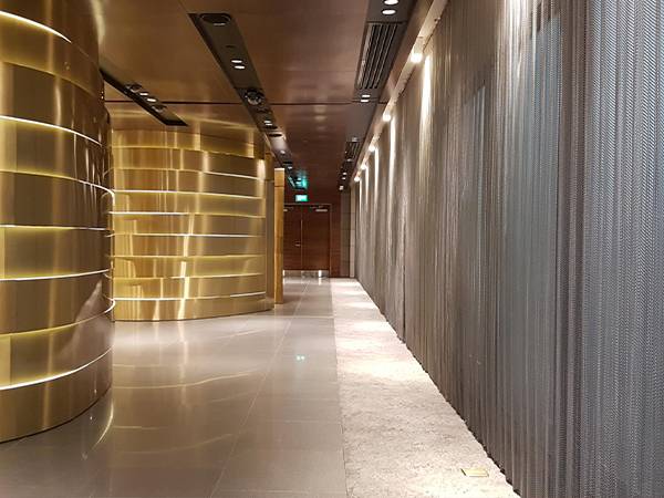 The corridors of the airport are decorated with silver metal coil drapery.