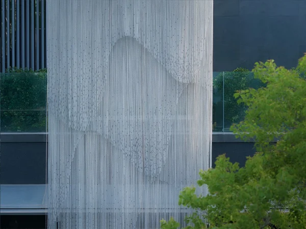 The garden landscape is decorated with a metal chain link curtain.