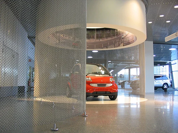 The perimeter of the auto exhibition is adorned with metal coil drapery.