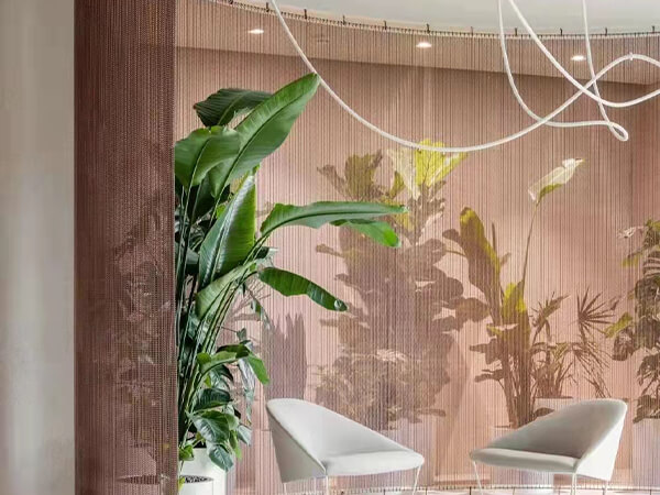 A metallic curtain gama serves as a decorative backdrop for the furniture showroom.