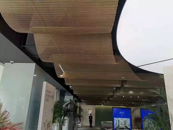 Sales office uses metallic curtain as lobby ceiling.