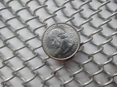 A piece of white coil fabric with a metal coin on its surface.