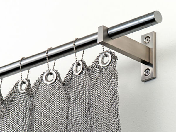 Brass chainmail curtain connected to the rod through rings.