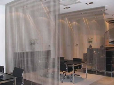 Woven wire drapery creates several separate rooms